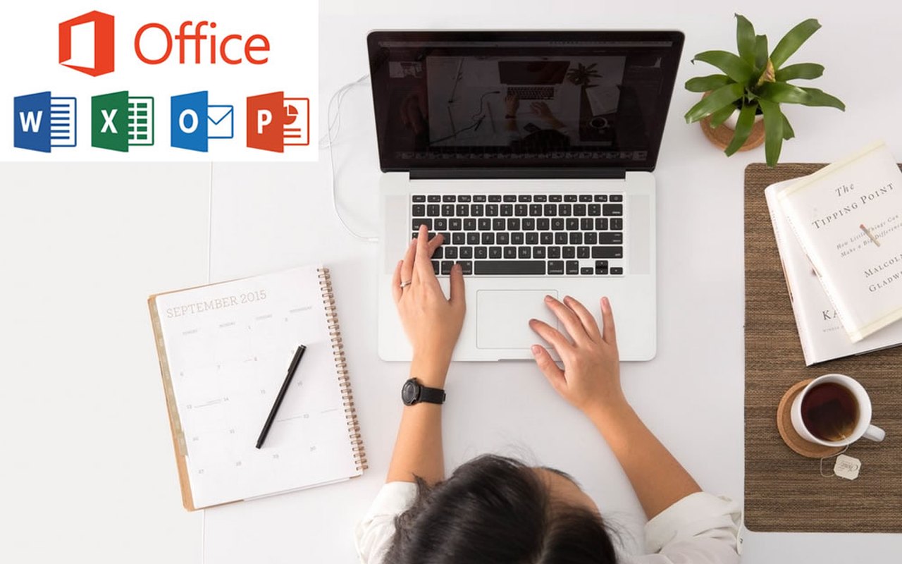 Person working at a laptop with Microsoft Office application icons